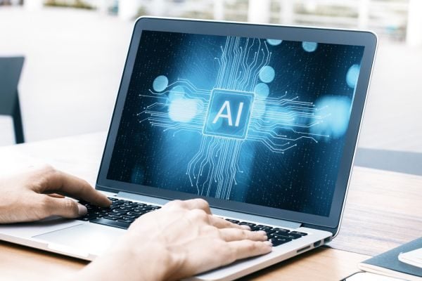 Business person using artificial intelligence tools on laptop