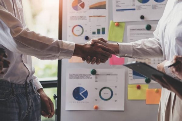 business-handshake-for-teamwork-of-business-merger-2023-11-27-05-25-20-utc-scaled